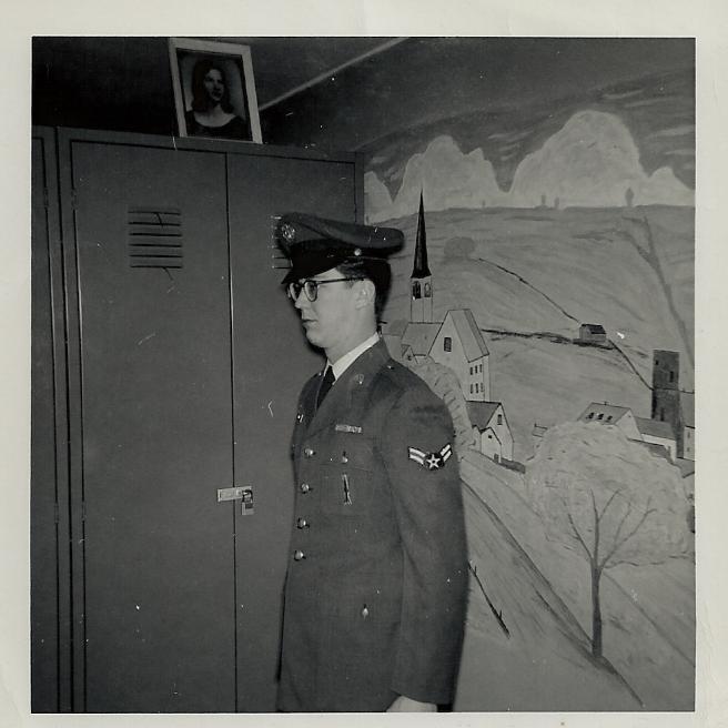 Me in my personal area in Class A Blues (note the mural on the wall and the picture of my girl on top of my locker)